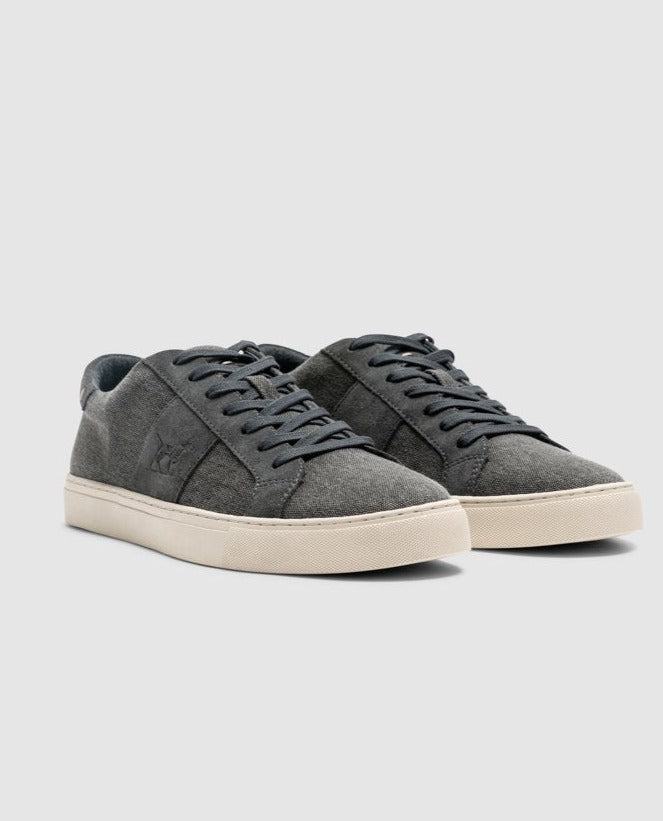 A pair of Rodd & Gunn Endeavour Sail Sneakers in gray suede with white rubber soles. Enhanced with suede leather trims, these shoes feature matching gray laces and a subtle embossed logo on the side. They boast a moulded footbed for extra comfort and are photographed against a plain light gray background.