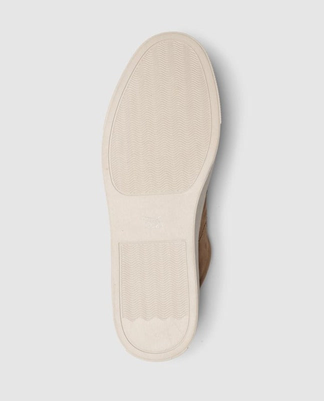The Rodd & Gunn Endeavour Spirit Sneaker features a bottom view with a light-colored sole, herringbone traction, and rectangular heel. Its casual vibe comes from a clean design possibly in nubuck leather, without visible branding.