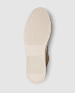 The Rodd & Gunn Endeavour Spirit Sneaker features a bottom view with a light-colored sole, herringbone traction, and rectangular heel. Its casual vibe comes from a clean design possibly in nubuck leather, without visible branding.