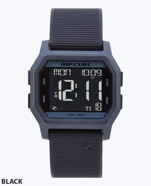 The Rip Curl Atom Digital Watch features a waterproof rectangular black case, black ribbed band, and digital display showing time, date, and more. "BLACK" appears in the lower left corner.