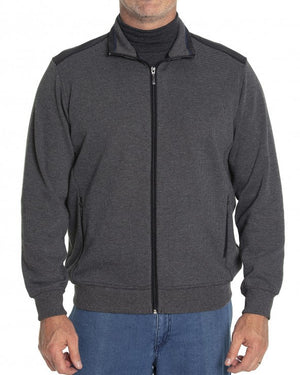 A person wearing the Breakaway Ryan Jacket, a stylish dark grey zip-up jacket with a high collar, over a dark shirt, paired with blue jeans. The person is standing against a plain white background.