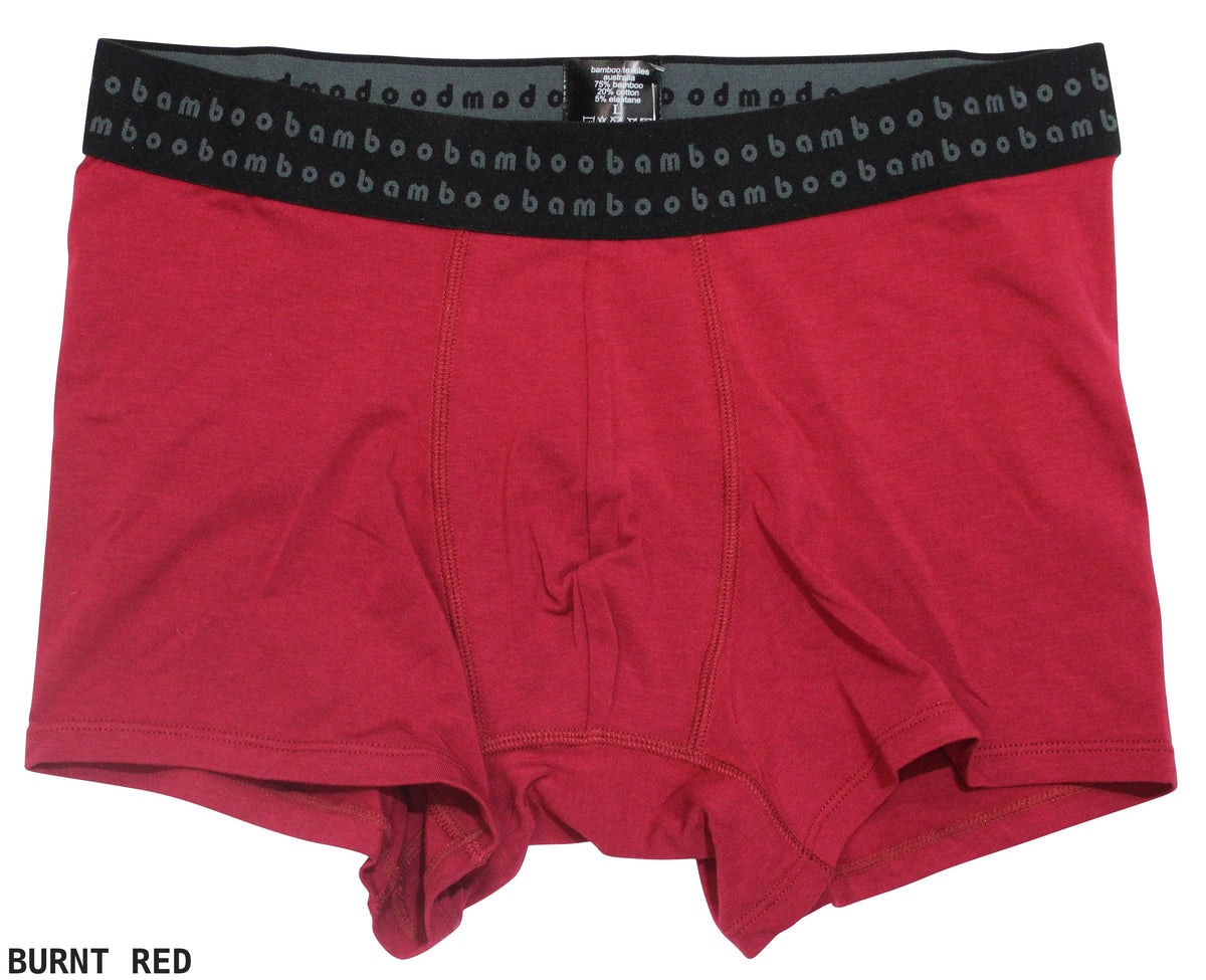 A pair of burnt red men's Bamboo Trunks with a black elastic waistband. The waistband features the repeated text "bambamboo" in light gray. The words "BURNT RED" are displayed in black text at the bottom left of the image, highlighting these comfortable boxer briefs.