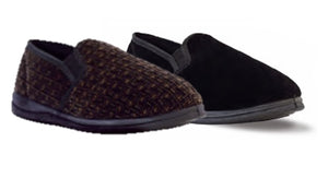 Two pairs of Twin Gusset Slippers are shown. The pair on the left features a woven brown pattern, while the pair on the right is solid black. Both have black soles and appear to be made of comfortable, soft fabric with memory foam for added coziness.