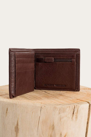 The Ringers Western Bayview Wallet, made from genuine leather, features embossed branding inside, includes card slots and a zippered pouch, and is elegantly displayed open on a wooden surface.
