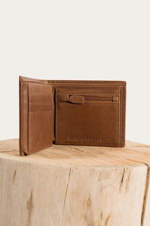 The Ringers Western Bayview Wallet, made of genuine leather, has multiple card slots and a spacious compartment. Displayed on a wooden surface, it features the embossed brand name inside.