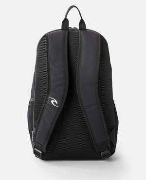 The Rip Curl Ozone 30L School Eco Backpack boasts a sleek black design with padded shoulder straps, a top handle, mesh padding, side pockets, and a laptop compartment. Made from recycled plastic, it also features a small logo on one strap for added style.