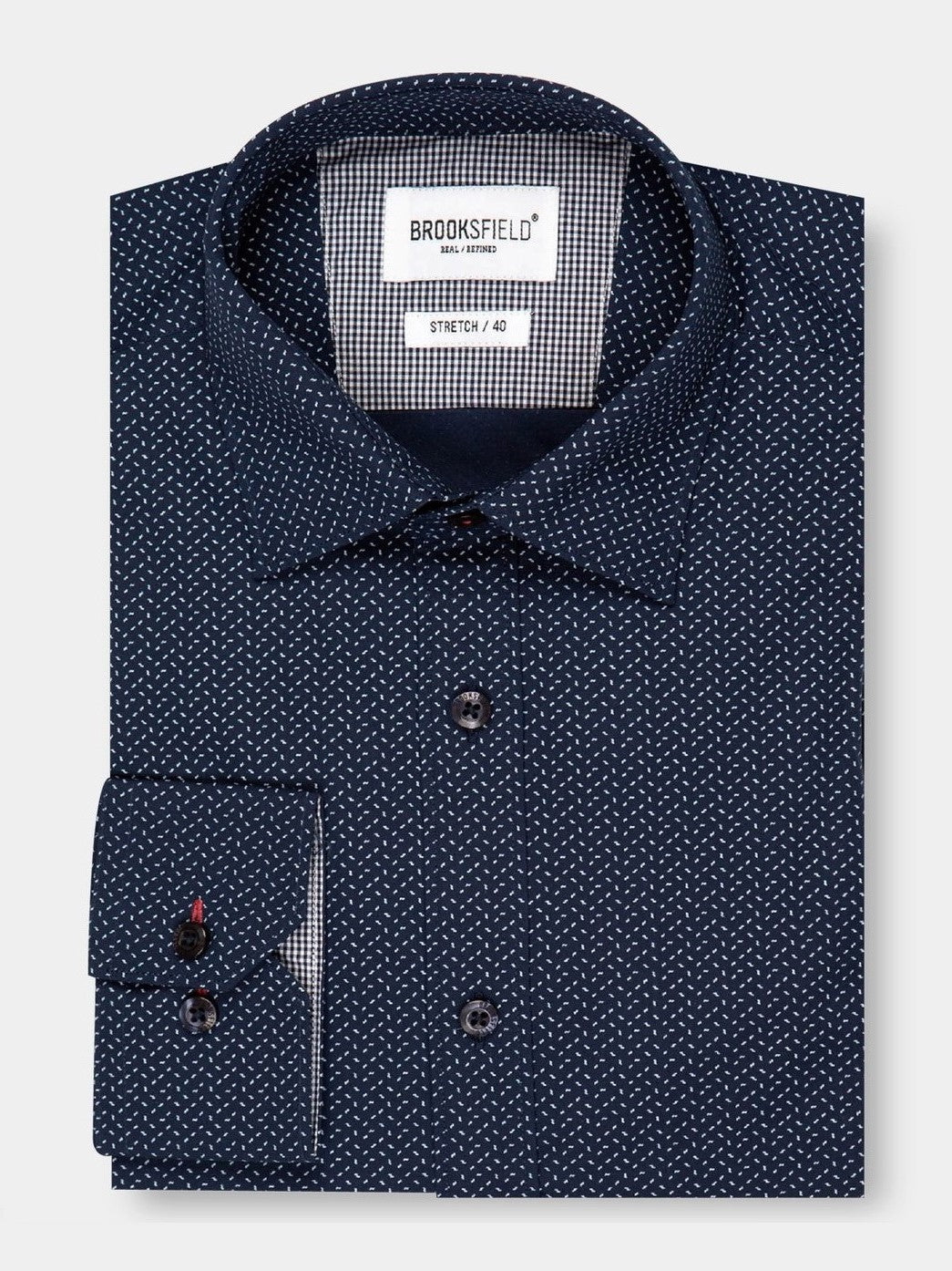 Dark blue long-sleeve Brooksfield Stretch Print Shirt with small white polka dots, buttoned and neatly folded for comfort. A tag inside the collar displays "BROOKSFIELD," offering additional sizing information.