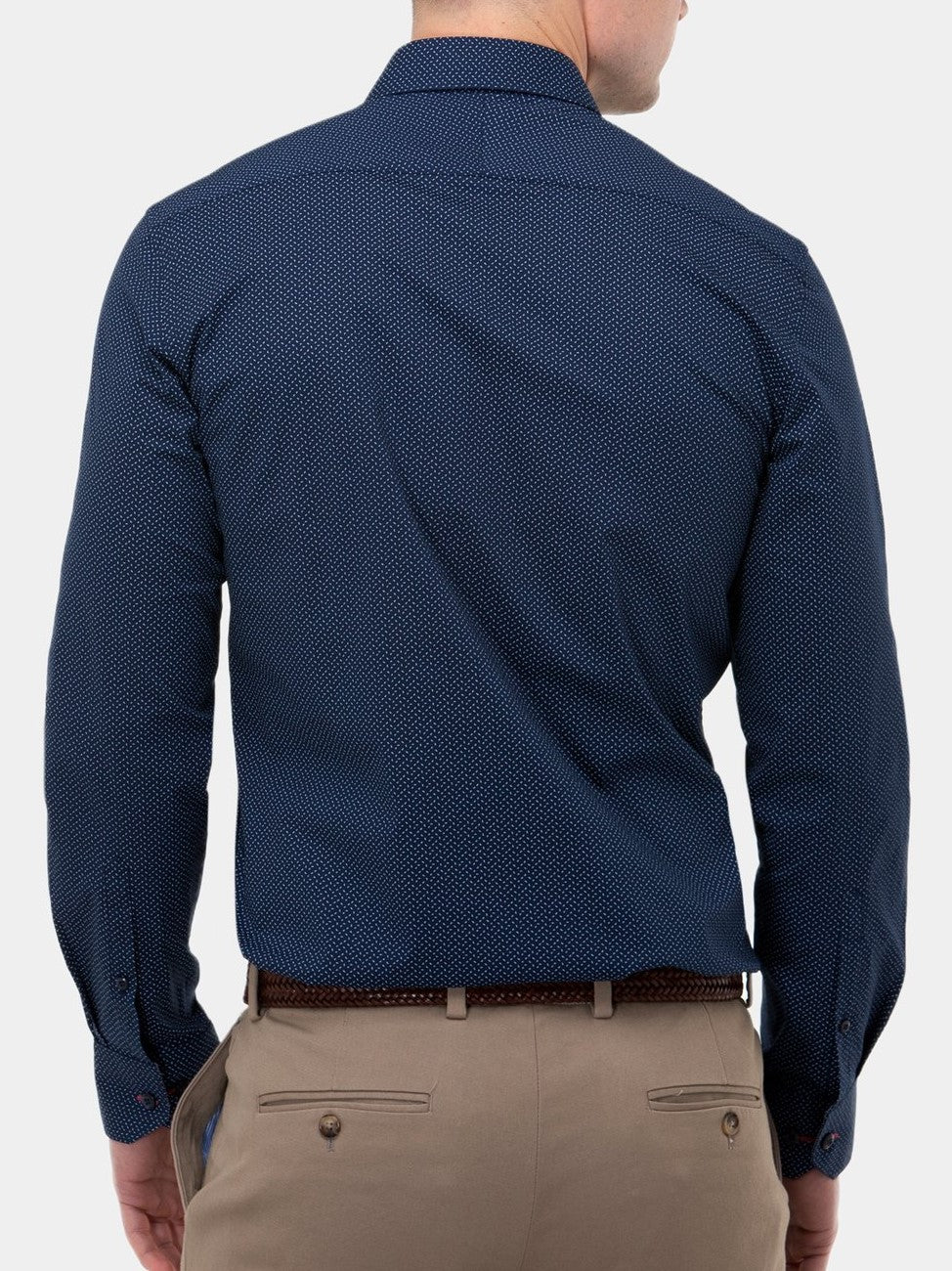 A man with short hair is wearing a navy Brooksfield Stretch Print Shirt, tucked into beige pants with a brown belt, against a plain white background.