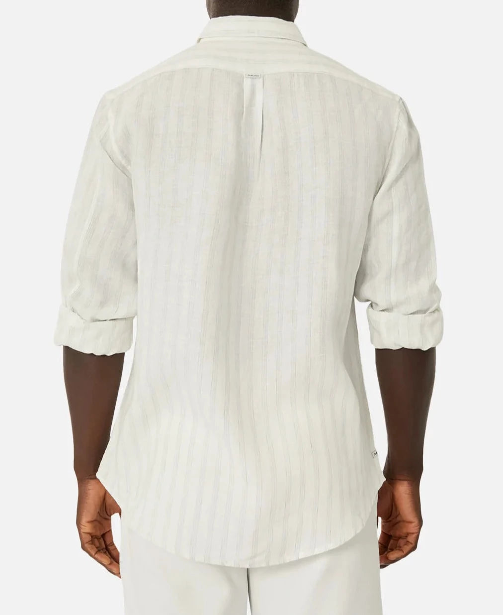 Wearing Industrie The Bilbao Long Sleeve Shirt in light color, a person with rolled-up sleeves is seen from the back, standing against a plain white background.