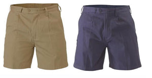 Two pairs of shorts are displayed. The pair on the left is khaki-colored with a front button and zip closure, pleated front, and belt loops. Made from natural cotton, they offer comfort and style. The navy blue pair has similar design elements. Both pairs are Bisley Drill Work Shorts and provide UPF50+ sun protection for outdoor activities.