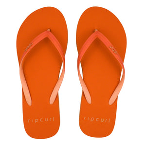 A pair of bright orange Rip Curl Bondi 2 Tone Thongs with matching orange straps laid side by side. The brand name "Rip Curl" is printed on the footbed near the heel in white text. Crafted from a durable thermo rubber compound, these flip-flops feature a simple, casual design that's perfect for summer.