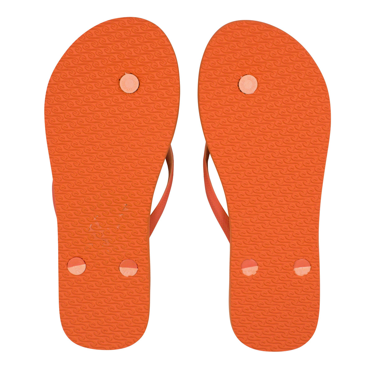 The Rip Curl Bondi 2 Tone Thongs in orange, viewed from the bottom, highlight the textured soles and button-like fastenings for the straps, crafted with durable thermo rubber compound.