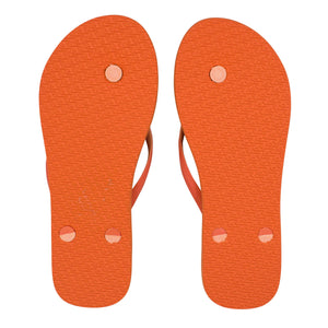 The Rip Curl Bondi 2 Tone Thongs in orange, viewed from the bottom, highlight the textured soles and button-like fastenings for the straps, crafted with durable thermo rubber compound.