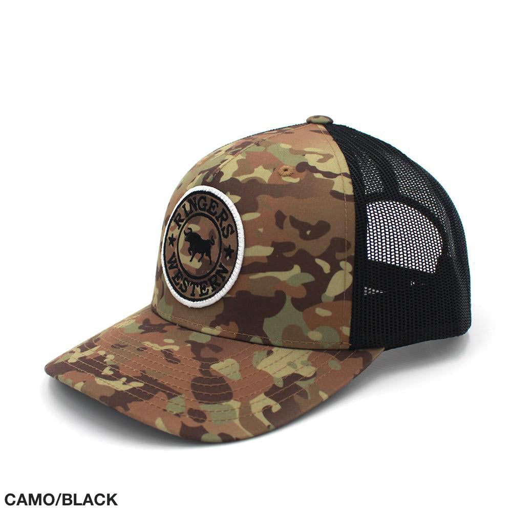 The Ringers Western Signature Bull Trucker Cap boasts a camouflage pattern on the front panels and brim, complemented by black mesh back panels. It features a distinctive patch on the front showcasing an outline of a kangaroo with the text "Ringers Western." An adjustable strap at the back ensures a customizable fit. Text at the bottom states "CAMO/BLACK.