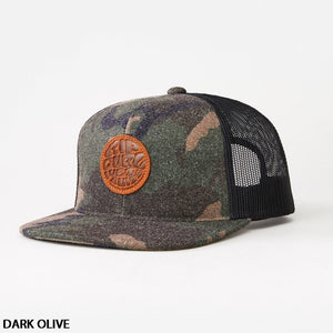 The Rip Curl Premium Wetty Trucker is a dark olive camouflage-patterned hat featuring a black mesh back and an orange circular patch on the front with embossed text and designs. It includes an adjustable strap for a perfect fit and is photographed against a plain white background. "DARK OLIVE" text appears in the bottom left corner.