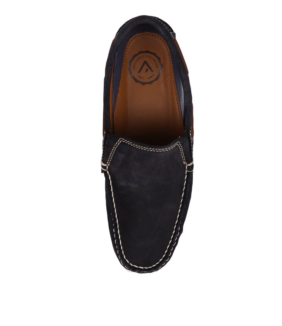 Top view of the Colorado Rocana Leather Slip On in dark blue leather with white contrast stitching, brown insole, and a circular logo at the heel. This classic loafer offers comfort and timeless style.
