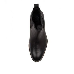 Top view of a single Colorado Brumby Boot in black, featuring a rounded toe, elastic sides, and a pull tab at the back. The leather boot boasts a sleek, polished finish with a visible stitched sole.