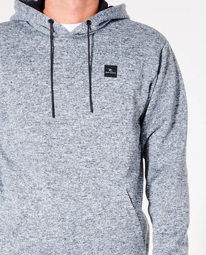 A person wears a light gray, speckled Rip Curl Anti Series Crescent Hood with drawstrings and a small black logo on the left chest. The durable water-resistant material and Anti Series technology enhance functionality. The plain white background highlights only the upper body.