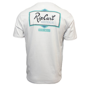 The Rip Curl Crescent Desto Tee is a white, short-sleeved 100% cotton T-shirt showing the back, with a blue and green outlined rectangle, "Rip Curl Australia" text, and a "Born at Bells" label below for comfort and style.