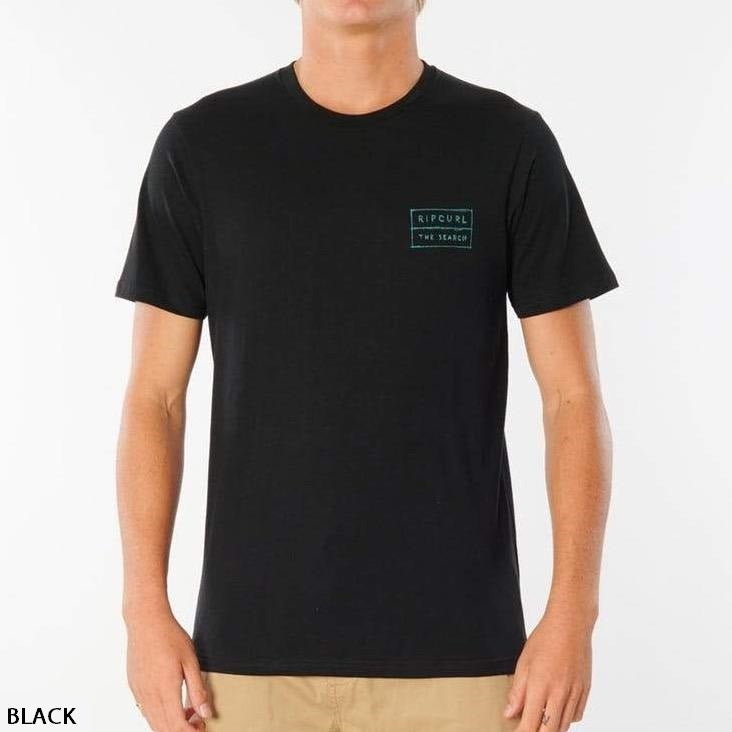 A person is wearing a Rip Curl 50/50 Scratch Tee, a plain black, 100% cotton shirt with short sleeves. This comfortable tee features a small green logo on the left chest with the text "RIP CURL" and "THE SEARCH." The background is plain white, and the word "BLACK" is written in the bottom left corner.