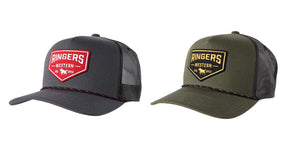 Two Ringers Western Garage Trucker hats with the brand's logo embroidered on the front patches. The hat on the left is dark gray with a red and white patch, while the one on the right is olive green with a black and yellow patch. Both hats feature an adjustable strap, black mesh back, and intricate embroidered details.