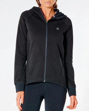 Against a plain white background, a person wears the Rip Curl Anti Series Flux II Zip, a black water-resistant zip-up hoodie with a small chest logo. It's paired with black pants and designed for winter wear. Their face isn't visible.