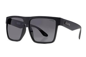 A pair of black, square-framed Liive Greed Sunglasses with dark, polarized grey lenses is displayed against a white background. The brand name "LINE" is visible on the temples, and the word "GREED" is etched subtly on one of the lenses. The lenses offer excellent UV protection.