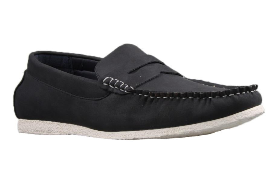 The UNcut Waves Shoe is displayed as a single black loafer-style shoe with a white rubber sole. It features visible white stitching along the top edge and over the foot area, offering a casual yet refined look. Available in UK sizing, these loafers seamlessly combine comfort and style.