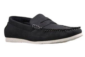 The UNcut Waves Shoe is displayed as a single black loafer-style shoe with a white rubber sole. It features visible white stitching along the top edge and over the foot area, offering a casual yet refined look. Available in UK sizing, these loafers seamlessly combine comfort and style.