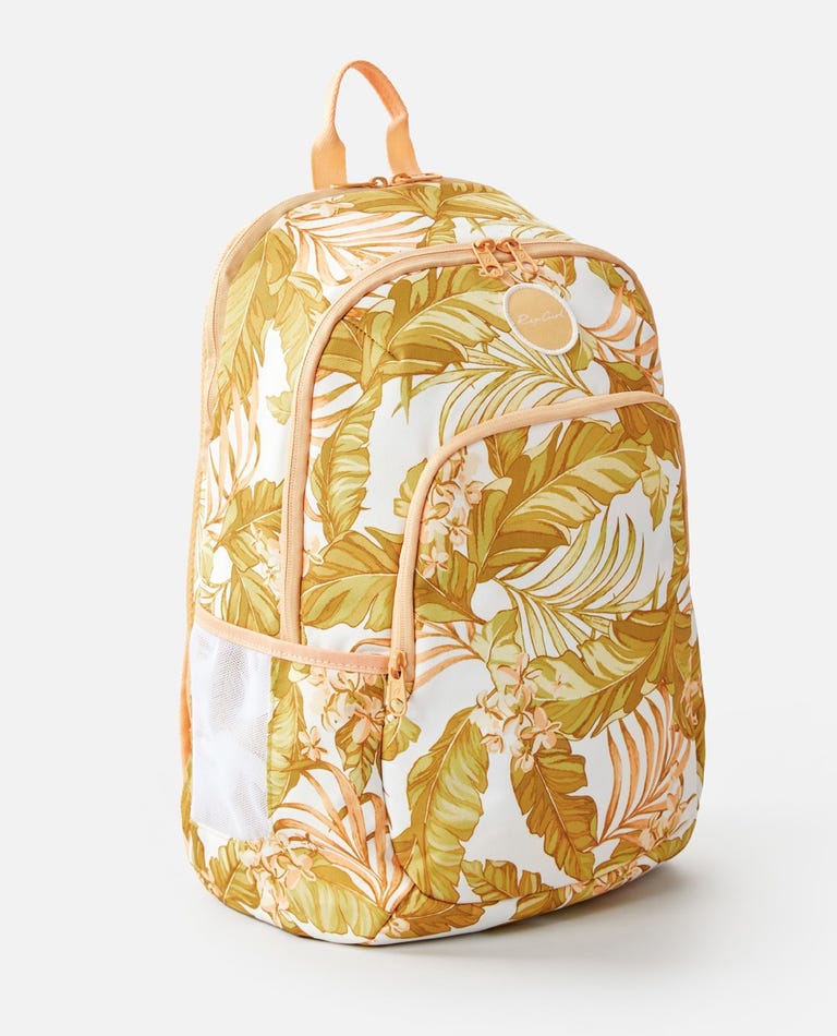 The Rip Curl Ozone 30L Multi Backpack sports a tropical leaf design in yellow, green, and white. It features adjustable straps, a front zipper pocket, side mesh pocket, insulated cooler compartment, and top handle. Light peach zippers and seams add style.