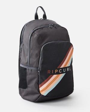 The Rip Curl Ozone 30L Multi Backpack in grey and black features a front compartment adorned with a vibrant stripe pattern in orange, beige, and light blue. Prominently displayed on the front pocket is the Rip Curl logo. The backpack offers a top handle, adjustable shoulder straps, and includes a laptop section for added convenience.