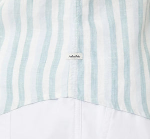 Close-up of Industrie The Linenman Shirt, featuring vertical light blue and white stripes with a button-down collar. A black "industrie" script fabric label is at the seam, while the lower part maintains a plain white finish in this relaxed fit shirt.