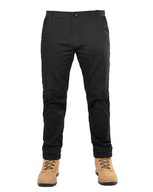 A person wearing the UNIT Ignition Stretch Pant and tan lace-up boots stands in front of a white background. The focus is on the lower body, highlighting the pants and boots.