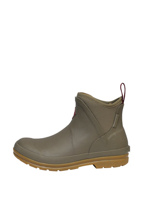 The Muck Boot Originals Women's Ankle Boot features an olive green rubber exterior, a brown sole, and a red pull tab. With a textured design and smooth finish, these boots have a waterproof build and antimicrobial footbed, showcased on a plain white backdrop.