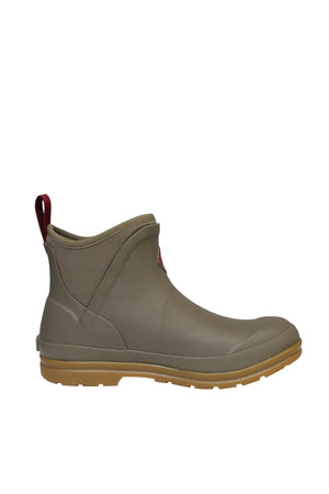 The Muck Boot Originals Women's Ankle Boot is olive green, with a light brown sole and red pull tab, ideal for wet or muddy conditions. This ankle-high rubber boot comes with an antimicrobial footbed and is fully waterproof.