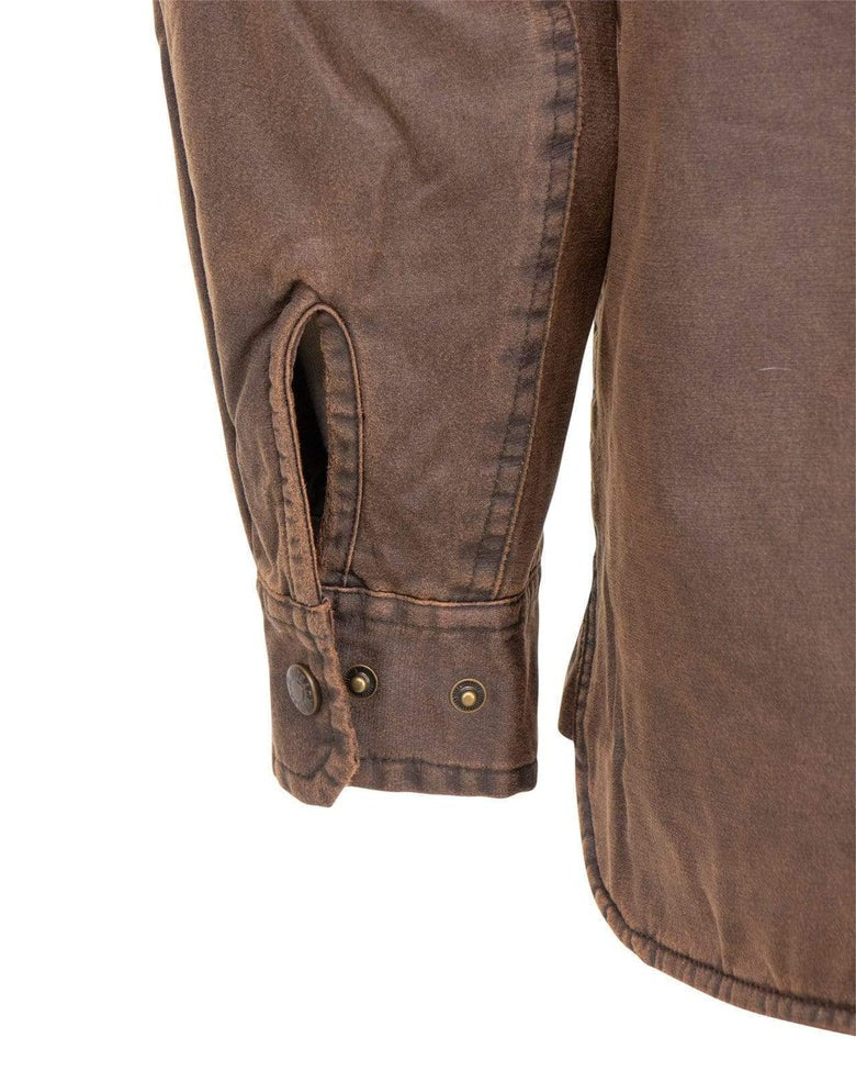 A close-up of a brown, worn-looking Outback Loxton Jacket sleeve reveals a buttoned cuff with brass snap fasteners. Featuring rugged-textured fabric in a relaxed, casual style, it's enhanced by a polar fleece lining for warmth.