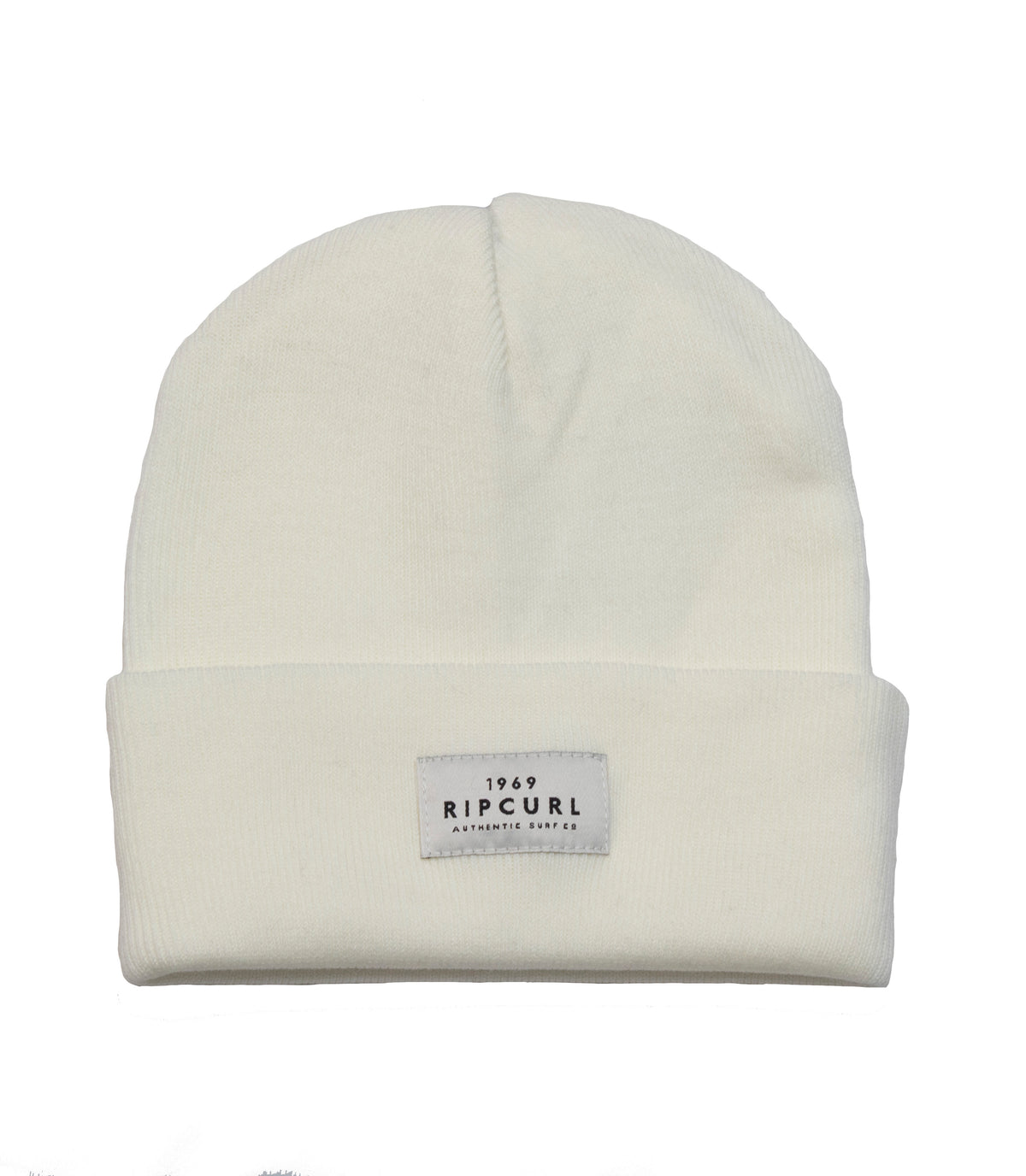 The Rip Curl Premium Surf Beanie is a white rib knit hat featuring a folded brim. A rectangular fabric patch on the front of the brim showcases the text "1969 RIP CURL A PRODUCT OF THE SURF CO." in bold black capital letters. This beanie boasts a simple, clean design.