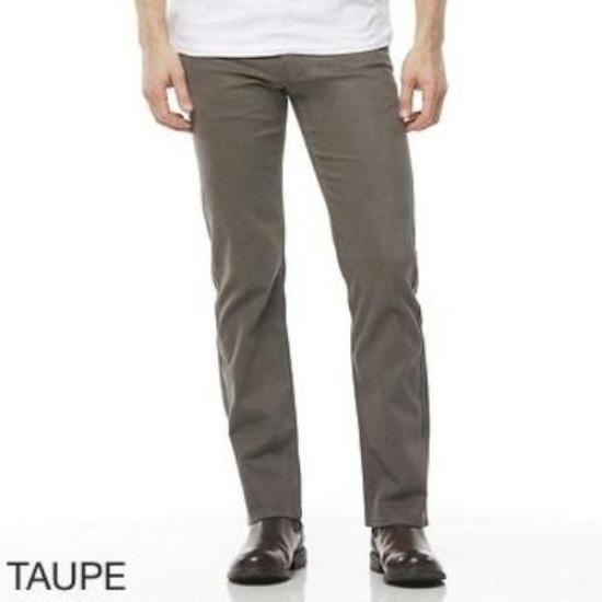 A person is wearing taupe-colored Riders Straight Moleskin Stretch pants with a white shirt. Only the torso and legs are visible. The person is standing with hands at their sides. Below the image, the word "TAUPE" is written in capital letters.