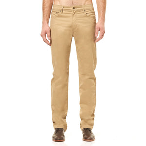 A person wearing stylish Riders Straight Pant Stretch in khaki stands with their hands by their sides. The slim-fit pants, crafted from a comfortable cotton elastane blend, feature a classic five-pocket design. Complemented by dark brown shoes against a plain white background, the outfit exudes understated elegance.