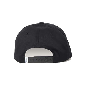 The image showcases the back of the black Ringers Western Grover Baseball Cap, which includes an adjustable strap and a small white tag on the left side of the strap.