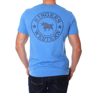 A person wearing a light blue, comfortable Ringers Western Signature Bull Classic T-Shirt with the words "Ringers Western" encircling the image of a bull on the back. The person is facing away, clearly displaying the design on the shirt, and is also wearing dark jeans.