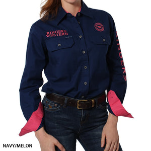 A woman wears the Ringers Western Signature Jillaroo Womens Full Button Shirt in navy with pink accents, "RINGERS WESTERN" embroidered on the chest and sleeve, pink cuffs and collar lining, paired with jeans. Made from 100% cotton.