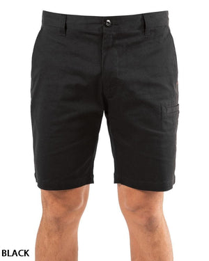 A person wears UNIT Ignition Stretch Short in blackβdurable stretch fabric, knee-length, with button and zipper closure, front and side pockets. Only the lower torso and upper legs are visible. βBLACKβ appears in the bottom left corner.