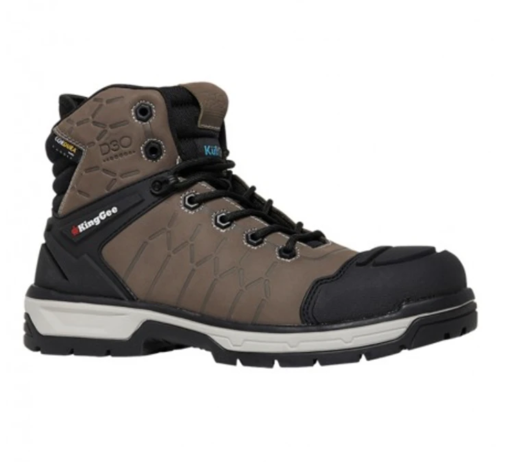 The King Gee Quantum Safety Boot is a single brown and black work boot with visible laces, a hexagonal stitch pattern, reinforced toe cap, and cushioning around the ankle. Featuring temperature regulating technology for comfort and branding labels "KingGee" and "D3O" on its side, the gray and black sole boasts a rugged tread pattern.