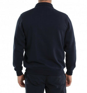 A person is standing with their back facing the camera, wearing the Breakaway Dex Snowy Mt Fleece Half Zip in navy blue and dark pants. The background is plain white.