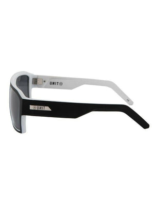 Side view of UNIT Vault Eyewear featuring a stylish black and white design. The sunglasses boast a lightweight frame and tinted lenses that offer UV protection. The temple arms are black on the outside and white on the inside, with the brand logo "ANTI" emblazoned in white on the sides.