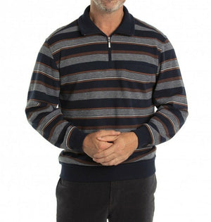 A person is wearing the Breakaway Jordan French Rib Half Zip, a long-sleeve, zip-up polo shirt with horizontal stripes in various shades of blue, gray, and occasional orange. The collar, cuffs, and hem are solid navy blue. This versatile jumper features a half-zip placket. The person has their hands loosely clasped in front of them.