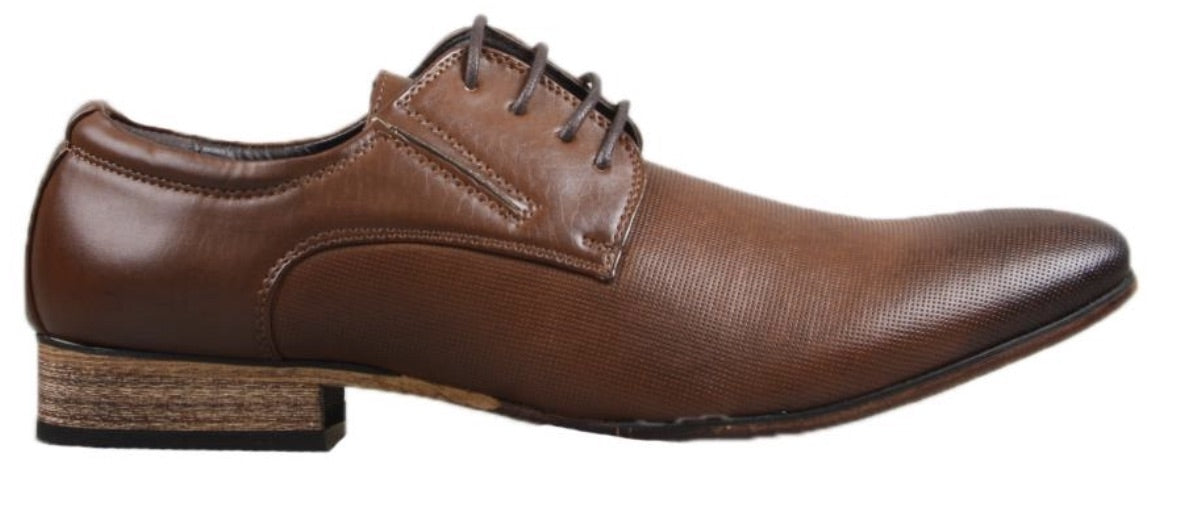 The UNcut Charles Shoe, a men's lace-up dress shoe with a pointed toe, textured leather-like finish, and wooden sole, is displayed in a side profile view on a white background. This elegant design features a lace-up closure and is available in UK sizing.