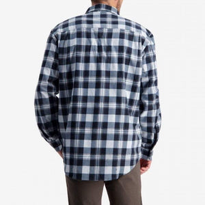 A person is shown from the back, wearing a blue and white plaid shirt from the Swanndri Egmont Full Button Flannelette Twin Pack, made of 100% brushed cotton. The person also wears brown pants, and their hands are relaxed by their sides. The background is plain white.