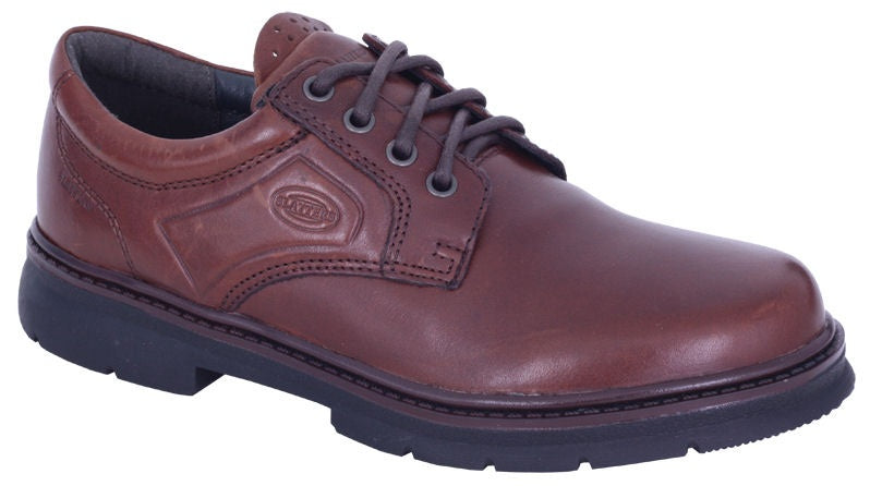 The Slatters Senator is a single brown leather lace-up shoe with a leather upper and black rubber sole. It is designed with an accent seam and a logo on the side, featuring a padded collar around the ankle for added comfort.
